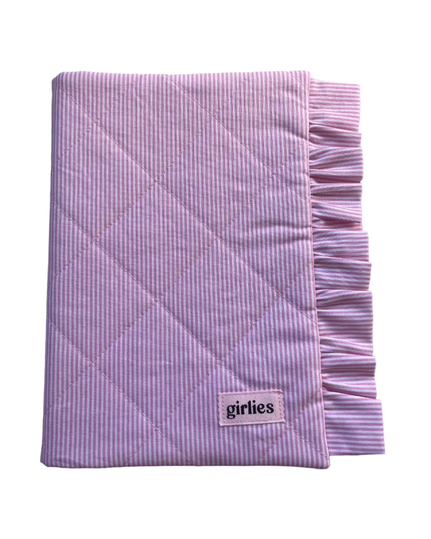 Pink and white striped quilted blanket with a ruffled edge and a small 'girties' brand label, shown on a light gray background.